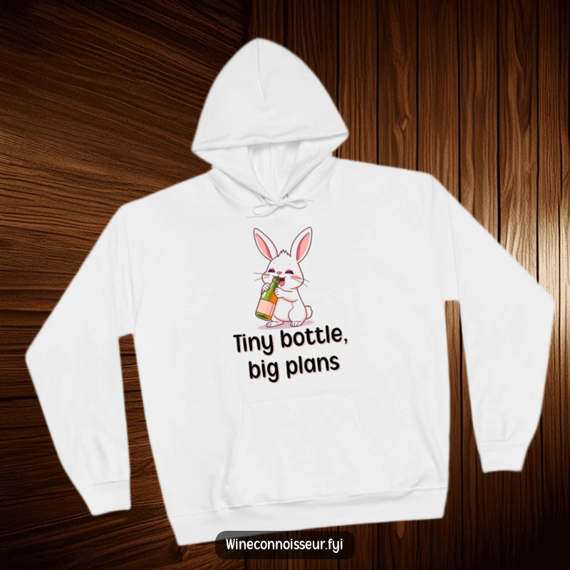 Funny warm hoodie with a determined rabbit character enthusiastically uncorking a miniature wine bottle, radiating a spirit of celebration.