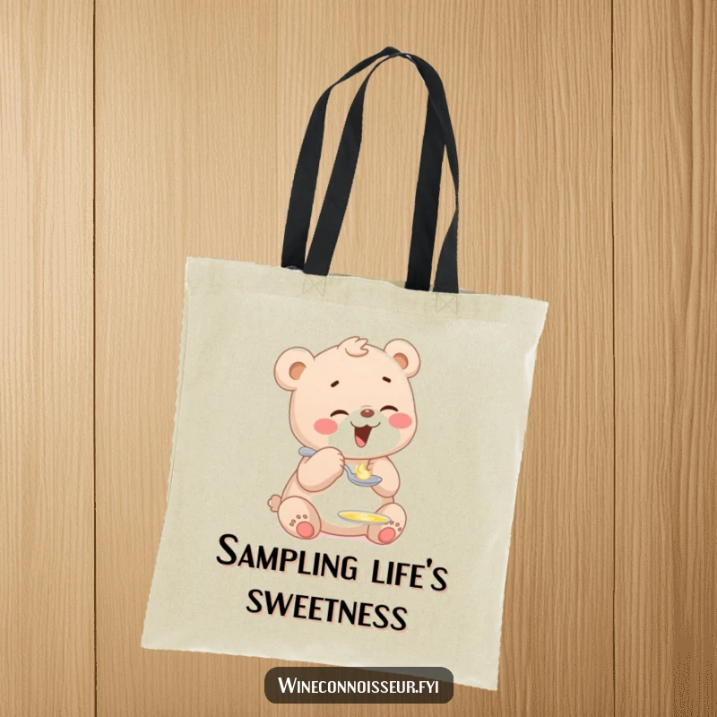 Funny tote bag featuring a giggling bear cub character sampling a sweet drop of liquid from a tiny spoon, illustrating playful joy.